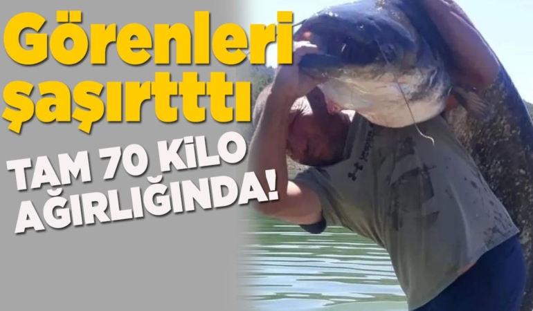 70 kilogramlık balıkla poz verdi